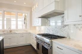 Kitchen With White Cabinets And Full Height Marble Slab Backsplash By Island Modern White Kitchen Cabinets White Modern Kitchen White Kitchen Marble Backsplash