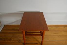 We also carry a couple of teak folding tables that might be just right for a boat or a condo balcony. Georg Jensen For Kubus Danish Teak End Table With Magazine Shelf Galaxiemodern