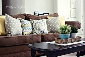 The contrast between the two colors creates a warm pop that is both cozy and aesthetically pleasing. Mixing Throw Pillows House By Hoff Brown Couch Living Room Brown Sofa Living Room Brown Living Room Decor