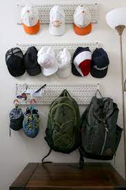 Pegboard Storage As A Hat Rack And Back Pack Hook Is A Great Idea For Guys Room Peg Board Guys Room Pegboard Storage