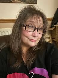 Lady in 60s with salt and pepper hair