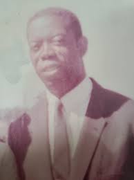 Teacher and students of St. Peter Claver School, in front of in front of  St. Peter Claver Church, Punta Gorda, Dec. 1903. The teacher is most likely  Antonio Enriquez, since he was