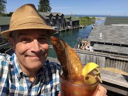The Chubby Mary. A Bloody Mary garnished with a smoked chub. At The Cove  restaurant in historic Fishtown. Leland, Michigan. And yes. With the camera  rolling I did try it.