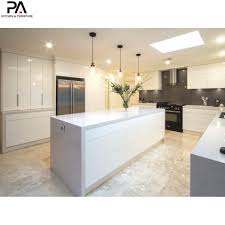 Integrated stainless steel appliances, cube range hood, gas cooktop, caesartsone quartz countertop, and breakfast bar. China Home Improvement Ready Made Modular All In One Modern White Lacquer Kitchen Cabinets China Kitchen Cupboard Home Furniture