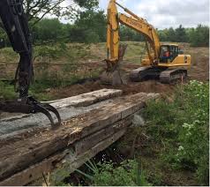 Coming to the labour cost, construction of a minor bridge requires excavators, back hoe loaders, loader with different bucket sizes, boom the very first thing i would like to tell you that if u want to built over a small pond or creek then the purpose of this bridge must also be tken into consideration. Stream Crossing Temporary