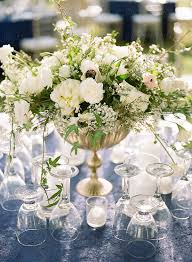 At this wedding at snake river ranch, wyoming, the green and white centerpieces by fleur de v events made a lovely addition to the bare wooden tables. Elegant Outdoor Wedding Reception Flowers By Seth Mourra Place Setting Wedding