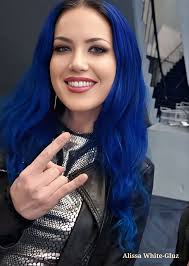 Alissa White-Gluz is the powerful frontwoman of the melodic death metal  band Arch Enemy, known for her fierce stage presence and extraordinary  vocal range. Born in 1985 in Canada, Alissa's journey into