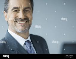 Portrait of mature businessman with greying beard in the city Stock Photo