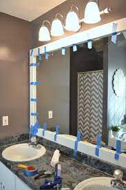 A mirror makes a room. How To Frame Out That Builder Basic Bathroom Mirror For 20 Or Less The Frugal Homemaker