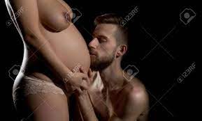 Family Parent Couple Of Pretty Sexy Woman Or Cute Pregnant Girl With Naked  Chest And Round Belly And Handsome Happy Bearded Man Hipster Isolated On  Black Background At Mothers Day, Copy Space
