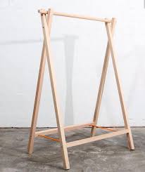 Suspended from the ceiling using a seamless pulley system. Pin By Boces Bi On Visual Merchandising Diy Clothes Rack Wood Clothing Rack Hanging Clothes Racks