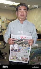 NEW YORK, United States - Toshimasa Tomiyama, publisher of Nikkan San, a  Japanese community paper based in Los Angeles, holds a copy of the paper in  Gardena, California, on Oct. 16, 2014.