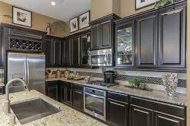 Even if you choose a kitchen filled with beautiful gray cabinetry, you can still treat your island as a separate furniture piece. New Homes For Sale New Home Construction Gehan Homes Kitchen Gallery Tan Granite Countertops Best Kitchen Countertops Kitchen Countertops