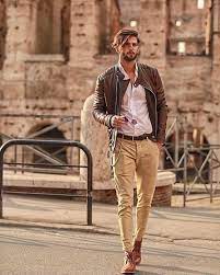 Season Transition Inspiration With A Brown Motorcycle Leather Jacket White Button Up Shirt Tan Chinos Brown Mens Street Style Mens Fashion Casual Mens Outfits