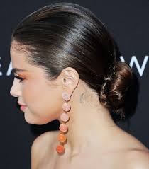 Spider web tattoo behind ear. Selena Gomez S 8 Tattoos Their Meanings Body Art Guru