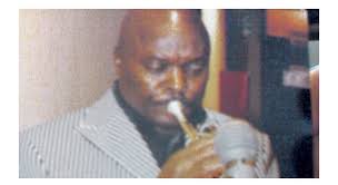 Backup male singer waving trumpet instead of playing