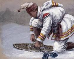 Image of Indigenous person wearing moccasins with snowshoes