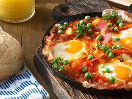 Huevos rancheros with fried eggs served on corn tortillas and smothered in cooked salsa. Huevos A La Flamenca Traditional Egg Dish From Andalusia Spain