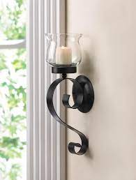 It is mounted to the wall with the same type of metal clip to attach most bathroom accessories to the wall. Scrolling Candle Wall Sconce This Candle Sconce Features A Lovely Fluted Glass Candle Cup That Rests Upon A Sim Wall Candles Candle Sconces Candle Wall Sconces