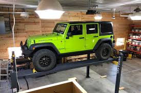 An asymmetric car hoist has arms of different lengths; Best Car Lifts For Home Garages In 2021 Roadshow