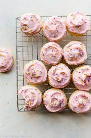 These Soft Cake Like Sugar Cookies Are Topped With Creamy Pastel Pink Buttercream And Sprinkles Sour Cream Is T Christmas Sugar Cookies Desserts Sugar Cookies