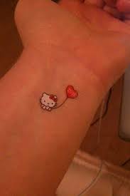 A Tiny Hello Kitty Tattoo On The Wris Looks Almost Like A Sticker Hello Kitty Tattoos Hello Kitty Tattoo Design Kitty Tattoo