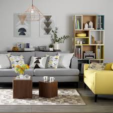Yellow and blue colored contemporary living room, sofa, armchair, carpet, concrete walls, potted plant and decors, copper pendant. Yellow And Grey Living Room Ideas Colour Combinations To Suit All Styles