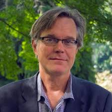 With my colleague, Professor Marco Salviato, I stand in front of our new  Automated Fiber Placement (AFP) robot at the University of Washington to  fabricate aerospace composite parts.