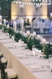 Head Table Dressed With White Linens Gold Pillar Candles White Taper Candles In Gold Candlestic Head Table Wedding White Chairs Wedding Taper Candles Wedding