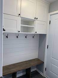 We made our entryway storage from metod kitchen cabinets: Updated Front Entrance Ikea Sektion Cabinets Shiplap Cherrywood Bench Ikea Floating Cabinet Ikea Mud Room Ikea Sektion Cabinets