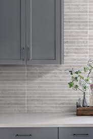 Carla aston, designer typically on my jobs, the electrician changes out all the electrical in the splash to a standard color that is as close to the backsplash field color as possible. Modern Light Gray Subway Backsplash Tile Contemporary Design Light Grey Backsplash Grey Backsplash Modern Grey Kitchen