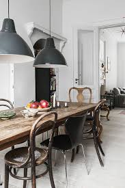 an antique table and modern chairs