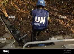 A U.N. Peacekeeper from the Bangladesh Army dismounts an armored personnel  carrier as part of a field training exercise