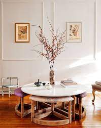 The round coffee table with seating underneath replicates faux leather lean around a pleasant veneer top with specific wood grain to improve the luxury and sophistication of the set. A Town House Filled With Reimagined Vintage Pieces Published 2012 Coffee Table With Seating Interior Decor