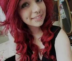 girl with dimple piercings and red hair