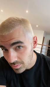 Haircare, hair styling and hair straightener concept. Joe Jonas Got A New Platinum Blonde Hair Color