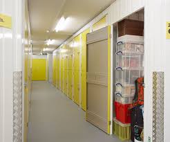Elevated view of a female office worker standing on ladder in file storage room. Student Storage Small Storage Units Big Yellow