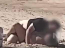 Couple confronted after having sex on packed public beach