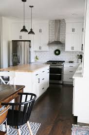 This stainless steel kitchen sink blends right into the kitchen with the rest of the stainless steel appliances. White Farmhouse Kitchen White Farmhouse Kitchens Black Kitchen Countertops Black Appliances Kitchen