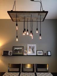 The next day, we fully removed the pot light fixtures and began attaching the stained wood planks to the ceiling. Diy Industrial Chandelier Dining Room Rustic Light Fixtures Diy Industrial Lighting Rustic Lighting