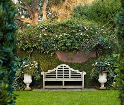 A Lutyens Style Bench Is Flanked By Graceful Urns Before Brick And Stucco Walls Traditional H Charleston Gardens Formal Garden Design Garden Landscape Design