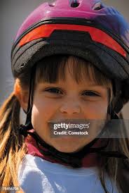 Girl On Bike With Helmet And Braces High-Res Stock Photo