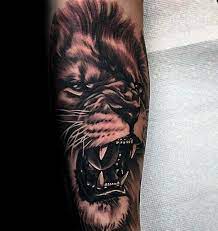 Cross with judah lion tattoos on the ribcage. 40 Lion Forearm Tattoos For Men Manly Ink Ideas