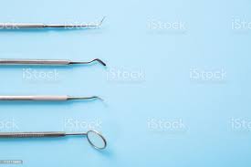 Dentist Tools Professional Steel Dental Instruments With A Mirror On Light Blue Background With Free Space Dental Health And Teethcare Concept Stock Photo Download Image Now Istock