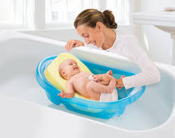 Line a sink or baby bathtub with a towel, and fill it about 2 inches full of warm water (around 100 degrees fahrenheit)—test it with your elbow or the inside of your wrist to make sure it's not too hot Bathing Your Newborn Summer Infant Baby Products