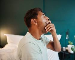 Image of person yawning in California while another person is eating breakfast in Texas