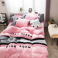 A pink upholstered headboard is placed against a blue wall and supports a bed dressed in white and pink bedding topped with a blue and pink pillow. Pink Bedroom Set Queen Novocom Top