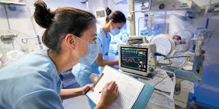 Intensive care unit with monitors and clinical staff providing post-surgical support
