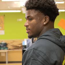 Caleb Downs hands out free turkeys and hams at the Mid-Ohio Market ahead of  Thanksgiving