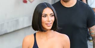 A large, ominous looking mountain stood high with it's shadow casted over the crashing waves below. Kim Kardashian Has Neon Green Hair Kim Kardashian Wears Green Wig Out In Miami
